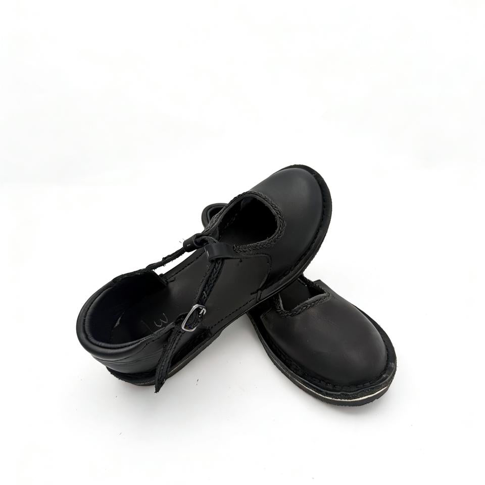 Pair of black leather shoes on a white background