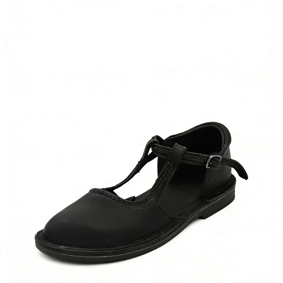 Black flat shoe with a strap on a white background