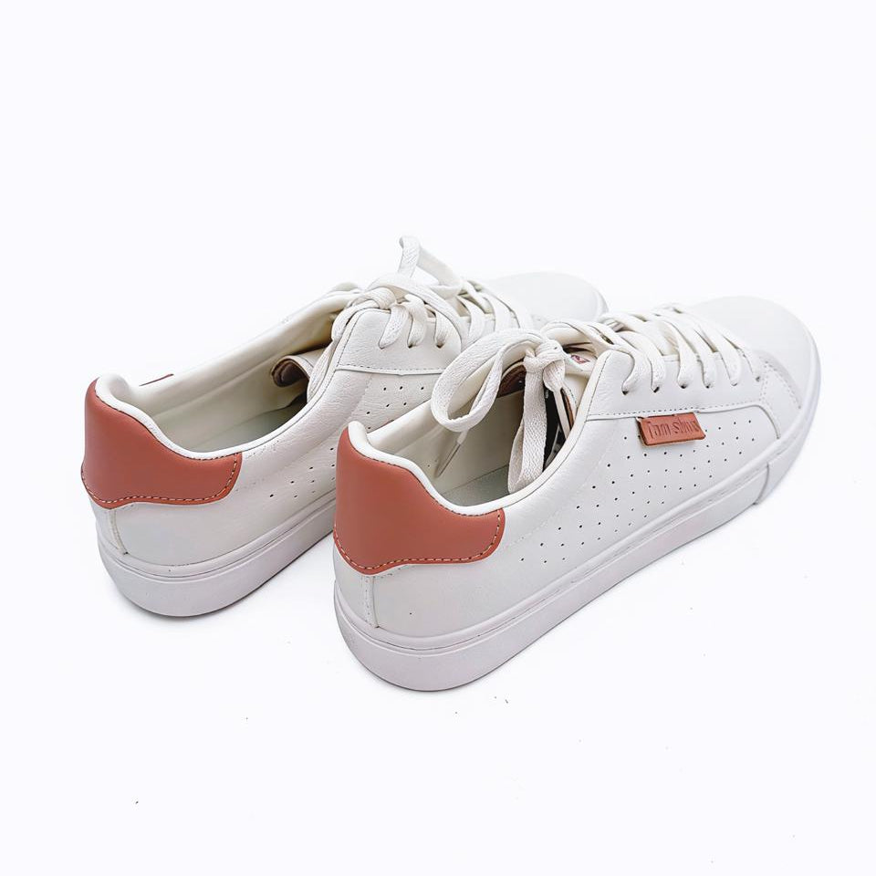 White sneakers with pink accents on a white background
