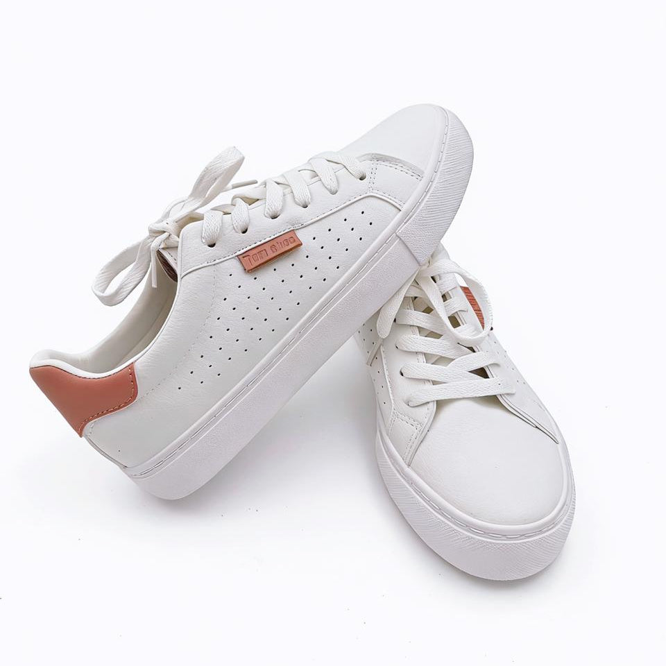 White sneakers with pink accents on a white background