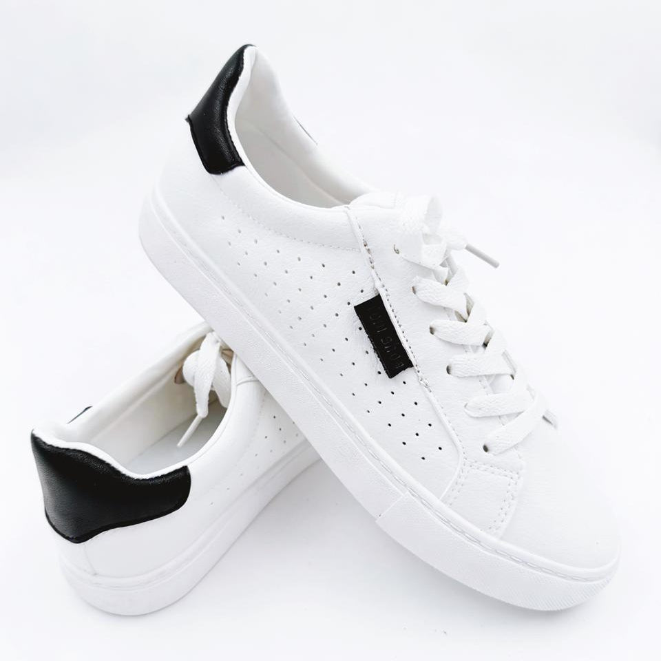 White sneakers with black accents on a white background