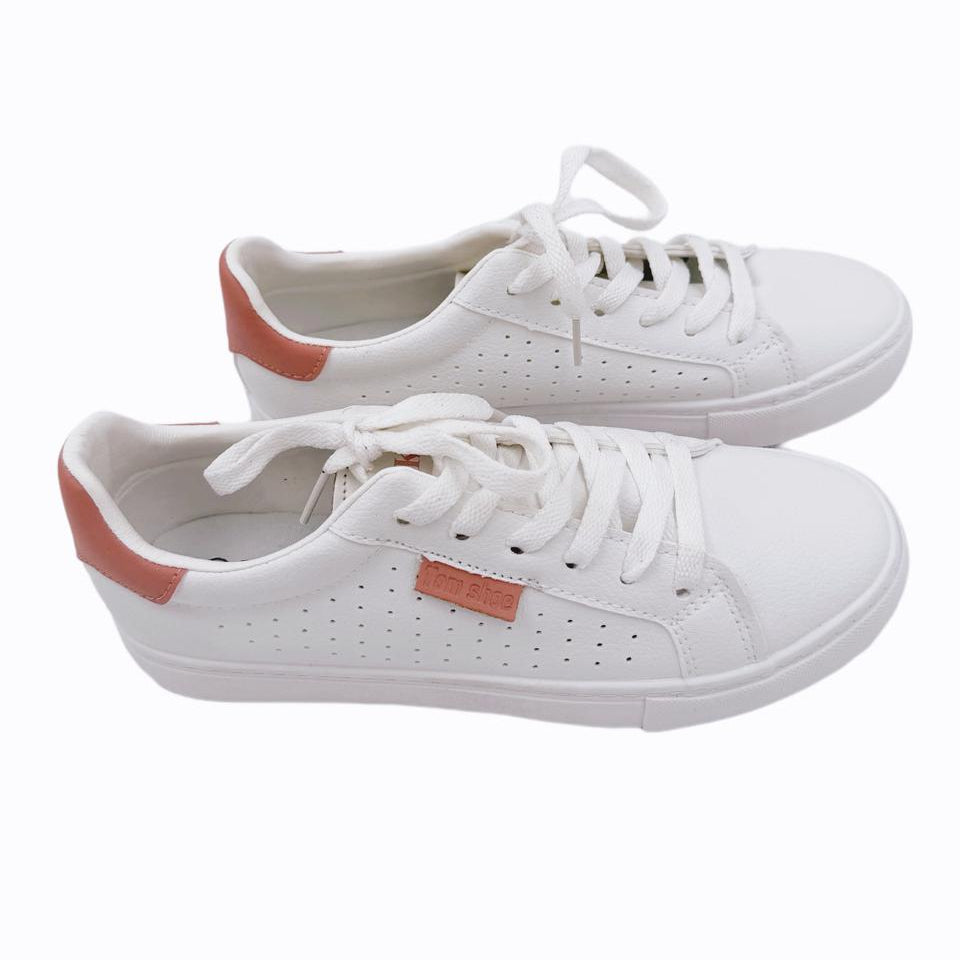 White sneakers with red accents on a white background