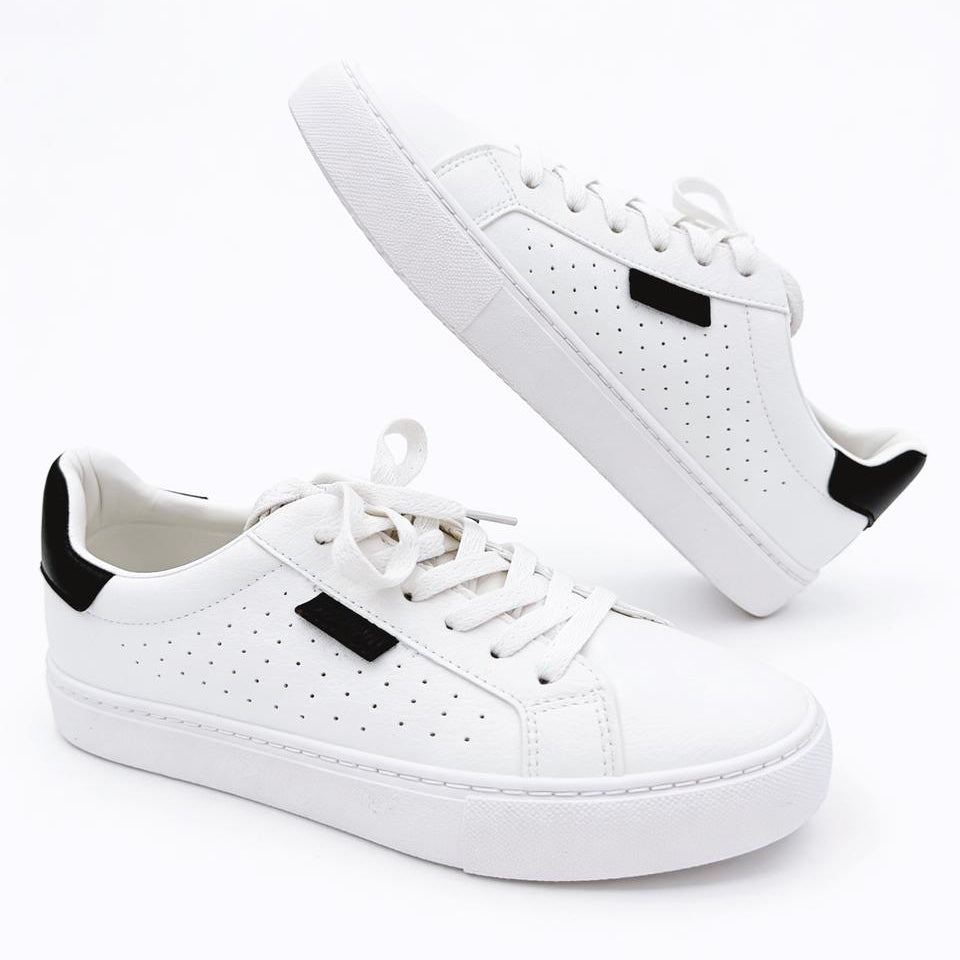 White sneakers with black accents on a white background